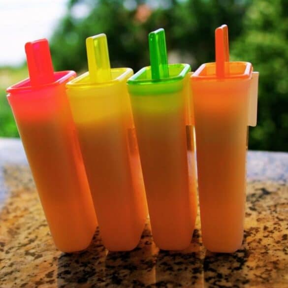 Colorful homemade popsicle molds on a granite countertop outdoors