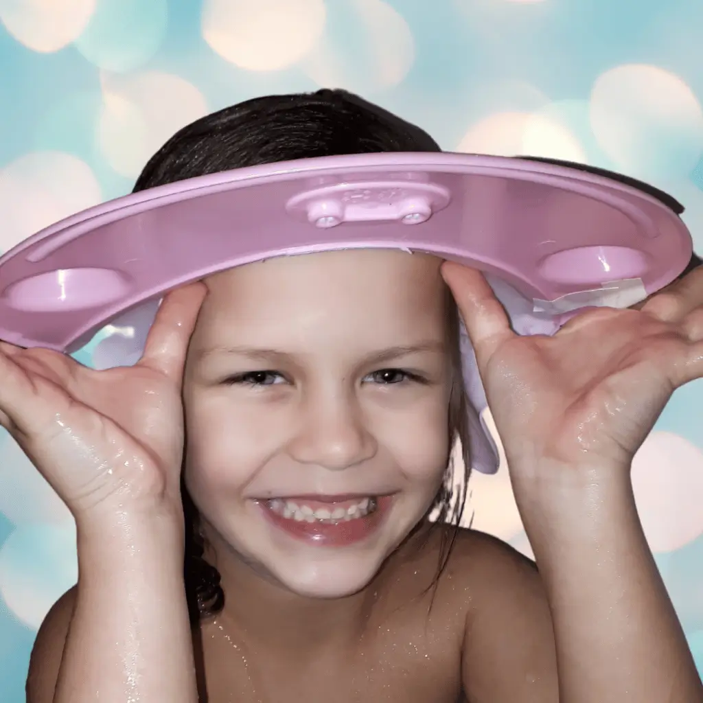 Non Toy Gifts for 1 Year Old - 25 Ideas From Moms 18 Smiling child wearing a pink shampoo visor, wet hair at bath time