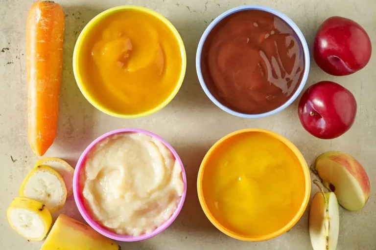 Transitioning to Solids: 10 Best Puree Recipes for Babies 5 Assorted baby food purees in bowls with carrot, banana, apple and plums